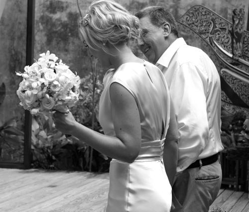 a man and a woman holding a bouquet of flowers at Tango Luxe Beach Villa, Koh Samui in Choeng Mon Beach