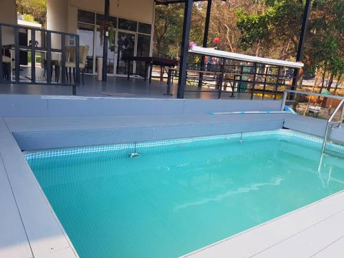 a swimming pool with blue water in front of a building at Pool&chill kohlarn in Ko Larn