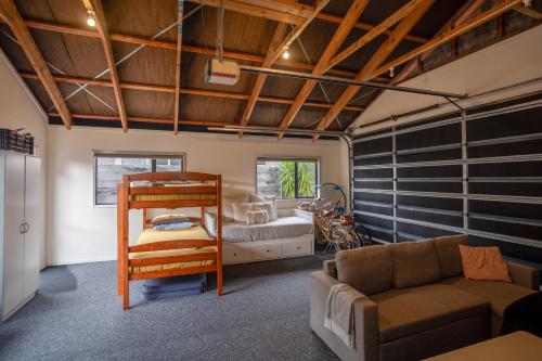 a living room with a bunk bed and a couch at Great for Couples - Families - Groups in Mangawhai
