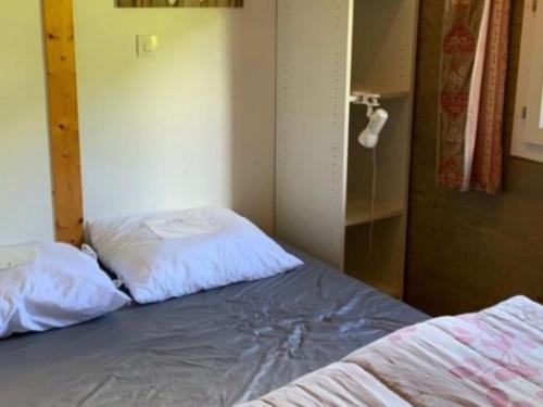 a bedroom with two beds in a room at Chalet 2 Pers avec Terrasse à Challes-les-Eaux - API-1-52-1283 in Challes-les-Eaux