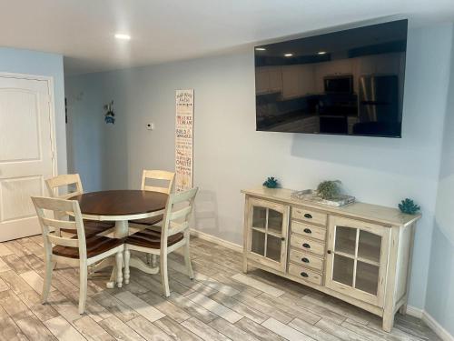 a dining room with a table and chairs and a dresser at Beachgate Condo Suites and Hotel 514 condo in Port Aransas