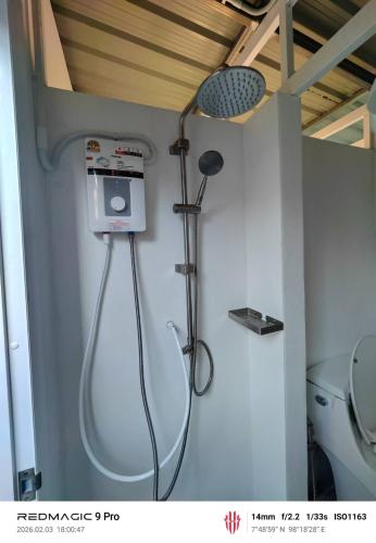 a shower in a bathroom with a toilet at Sleep On The Clouds in Ban Kata