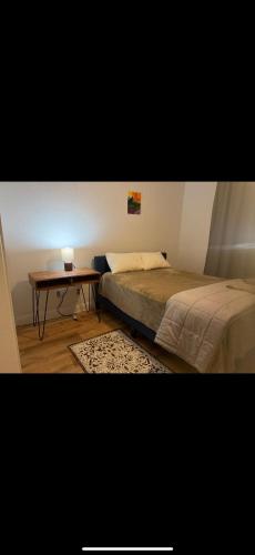 a bedroom with a bed and a small table at The Ark in Redding