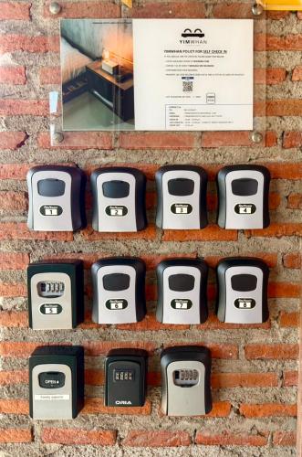 a brick wall with four dials on it at Yimwhan Hostel & Cafe Ayutthaya in Phra Nakhon Si Ayutthaya