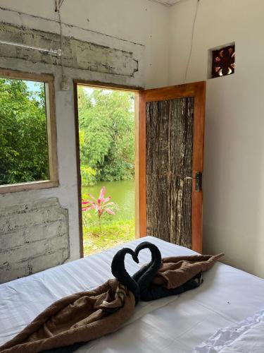 a heart decoration on a bed in a room with a window at Live lombok homestay in Batukliang