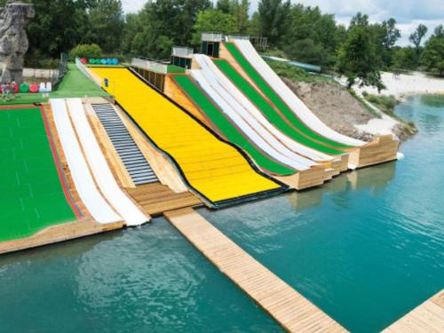 a row of colorful slides in the water at Chalet 8 Pers - Terrasse - Equipement bébé - API-1-52-1519 in Beaudreix