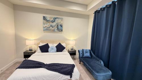 a bedroom with a bed and a blue curtain at 5 mins to NRG and The Medical Center The Houston Reston in Houston