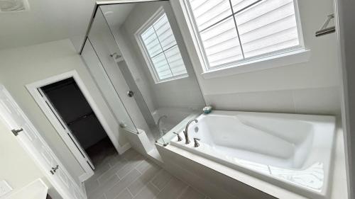 a white bathroom with a sink and a mirror at 5 mins to NRG and The Medical Center The Houston Reston in Houston