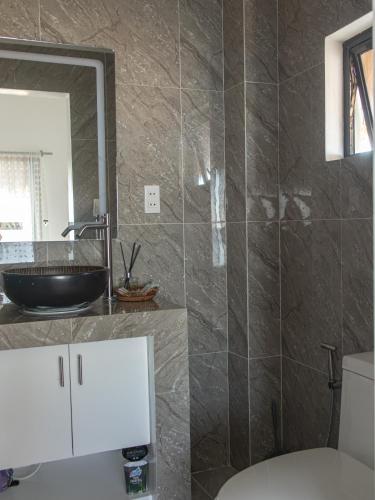 a bathroom with a sink and a mirror at HilNer's Beach Resort in Alegria