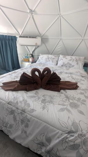 a bed with two wooden hearts on top of it at Sunshine's Hill in Ko Lanta