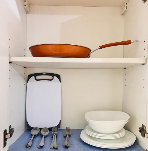 a kitchen with a shelf with a bowl and utensils at New 1BR in Mandaluyong 40SQM in Manila