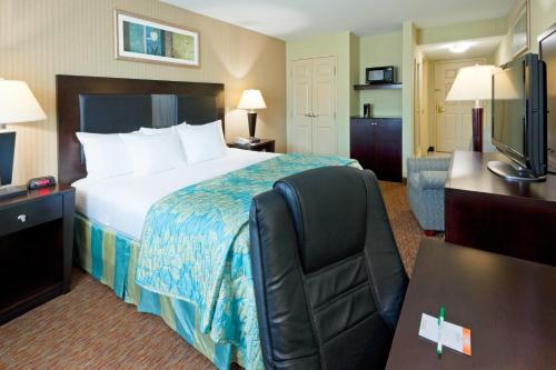 a hotel room with a large bed and a desk at La Quinta Inn by Wyndham West Long Branch NJ Shore Area in West Long Branch