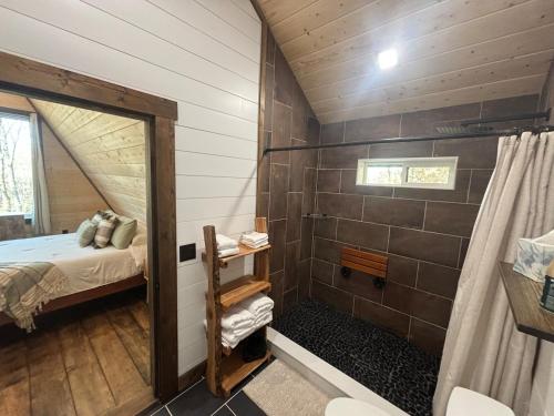 a bathroom with a shower and a bed in it at Eagles Rest in Murray