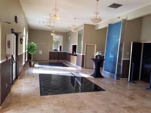 a large room with a lobby with a large floor at Ramada by Wyndham Glendale Heights/Lombard in Glendale Heights