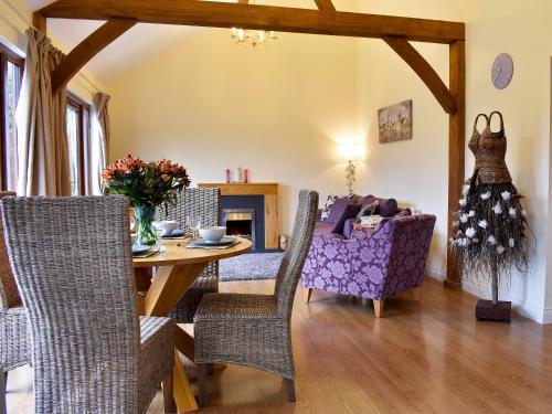 a living room with a dining room table and chairs at Lavender Lea in Landford