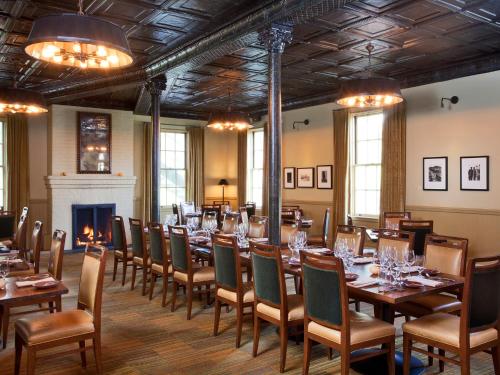 a dining room with tables and chairs and a fireplace at Cavallo Point in Sausalito