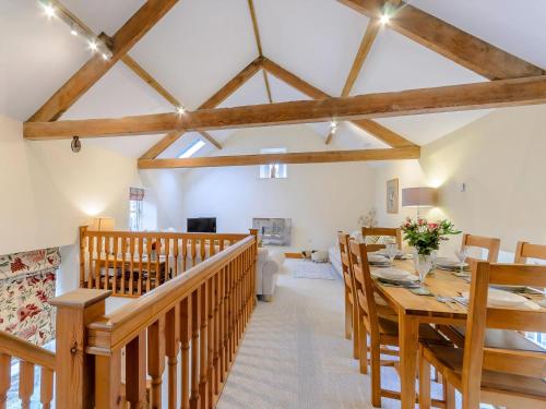 a dining room with a long wooden table and chairs at Westwood Barn in Brough Sowerby