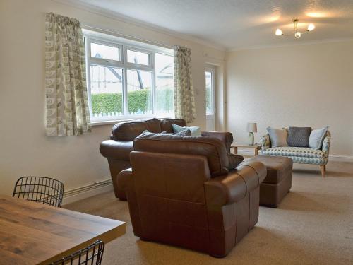 a living room with two couches and a table at La Falda in Sutton on Sea