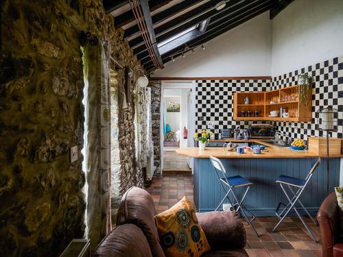 a kitchen with a table and a counter in a room at Bakery - Ukc4675 in Clynnog-fawr