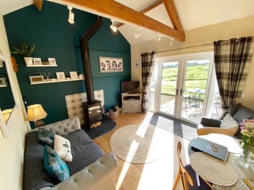 a living room with a couch and a fireplace at Mark Close Milking Parlour in Alston