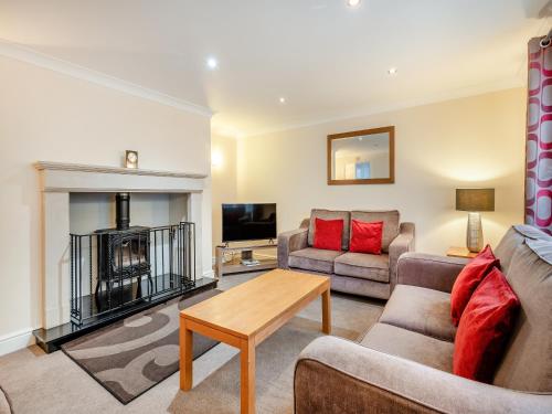 a living room with a couch and a table at The Willows in Sea Palling