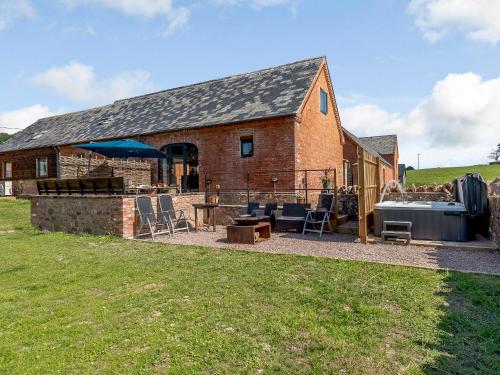a large brick building with a hot tub and a house at Go Cart Barn in Gloucester
