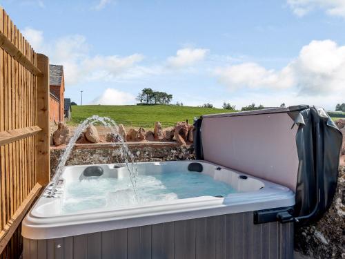 a hot tub with a fountain in a backyard at Go Cart Barn in Gloucester