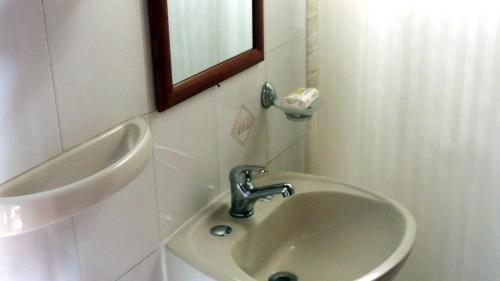 a bathroom with a sink and a mirror at Country del Sol Complejo Turistico in La Paloma