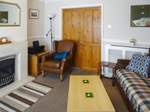 a living room with a couch and a chair at Bank View in Settle