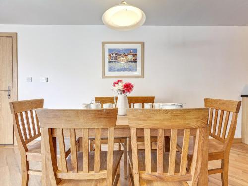 a dining room with a table and chairs at 4 Red Rock Apartments in Dawlish Warren