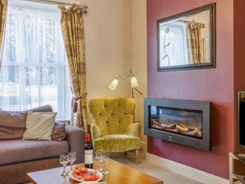 a living room with a couch and a fireplace at Jame's Cottage in Keswick