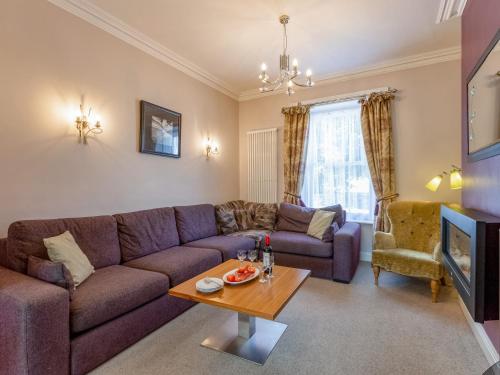 a living room with a couch and a table at Jame's Cottage in Keswick