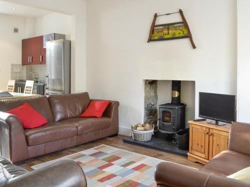 a living room with a couch and a fireplace at Viewington Lodge in Ballater