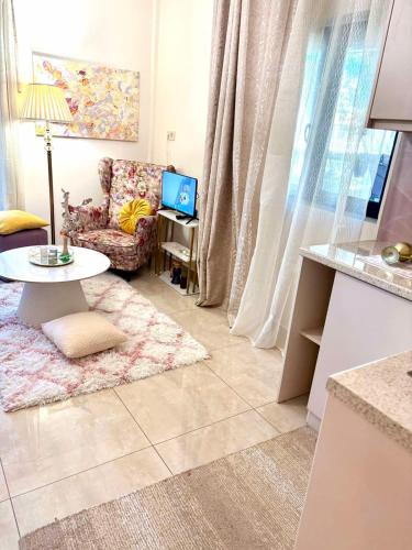 a living room with a couch and a table at Ducato di Aria , Luxury Apartments in Nafplio