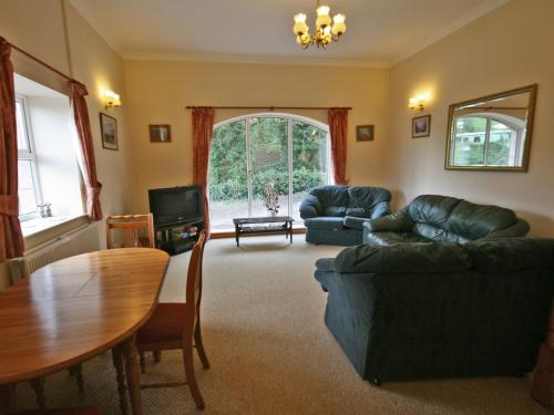 a living room with a couch and a table at Humbleton Falls in Wooler