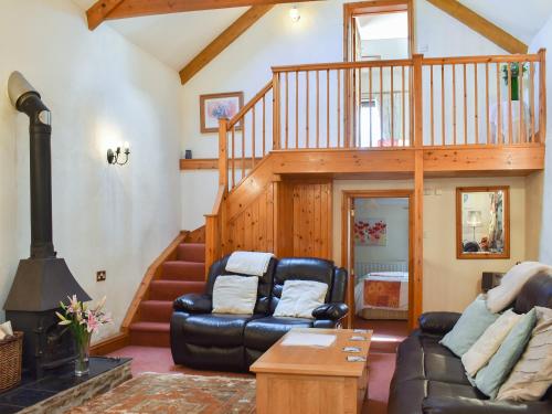 a living room with a couch and a staircase at Ricann - Ukc4244 in Lanreath