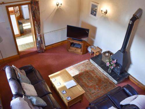 an overhead view of a living room with a couch and a television at Ricann - Ukc4244 in Lanreath