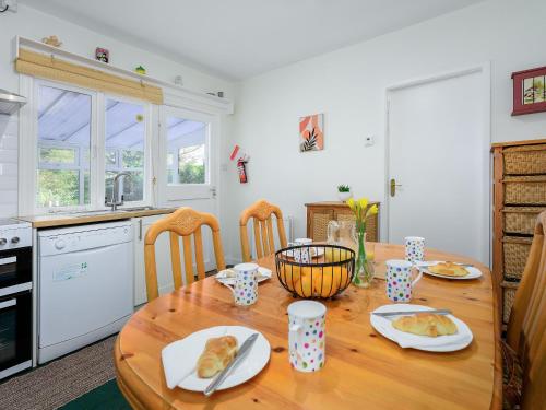 a kitchen with a wooden table with food on it at Cartref in Llysfaen