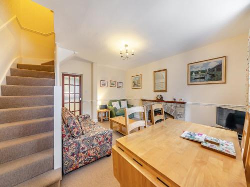 a living room with a couch and a table at Tweed Cottage in Alnwick