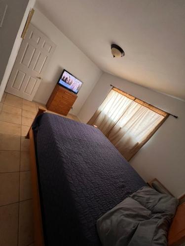a small bedroom with a bed and a television at South Mountain Savings in Phoenix