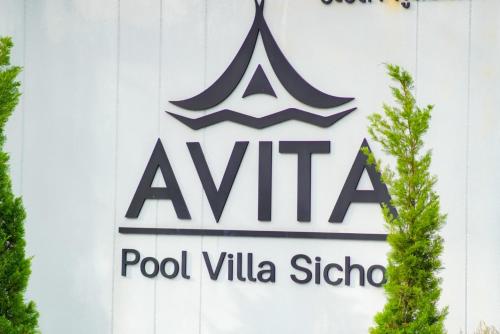 a sign on the side of a building at Avita Pool Villa in Sichon