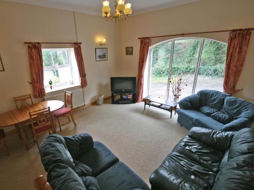 a living room with a couch and a table at Humbleton Falls in Wooler