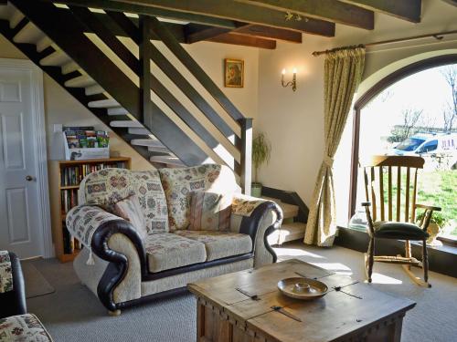 a living room with a couch and a coffee table at Sandsedge Cottage in Ellington