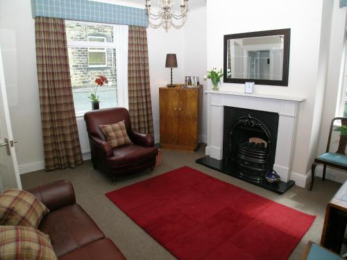 a living room with a couch and a fire place at Ted's House in Mytholmroyd
