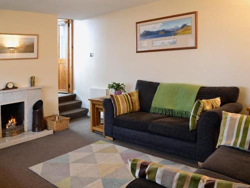 a living room with a couch and a fireplace at Bayview in Collieston