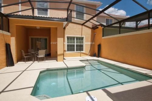 a swimming pool in the backyard of a building at Family 4-Bedroom Pool Home Near Disney World in Kissimmee