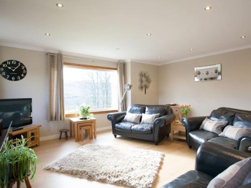 a living room with two couches and a television at Strone Farm House in Torcastle