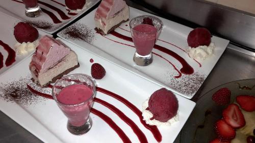 a plate of desserts with strawberries and ice cream at Auberge Du Cheval Blanc in Beaumont-Pied-de-Boeuf