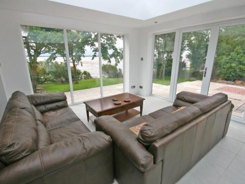 a living room with a couch and a table at Dornock Brow Cottage in Dornock