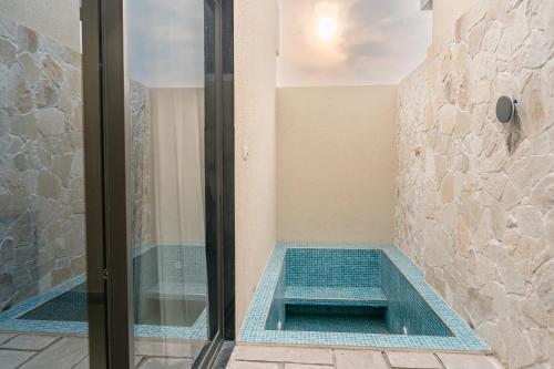 a swimming pool in a bathroom with a shower at KMR Hotels & Resorts in Bikaner